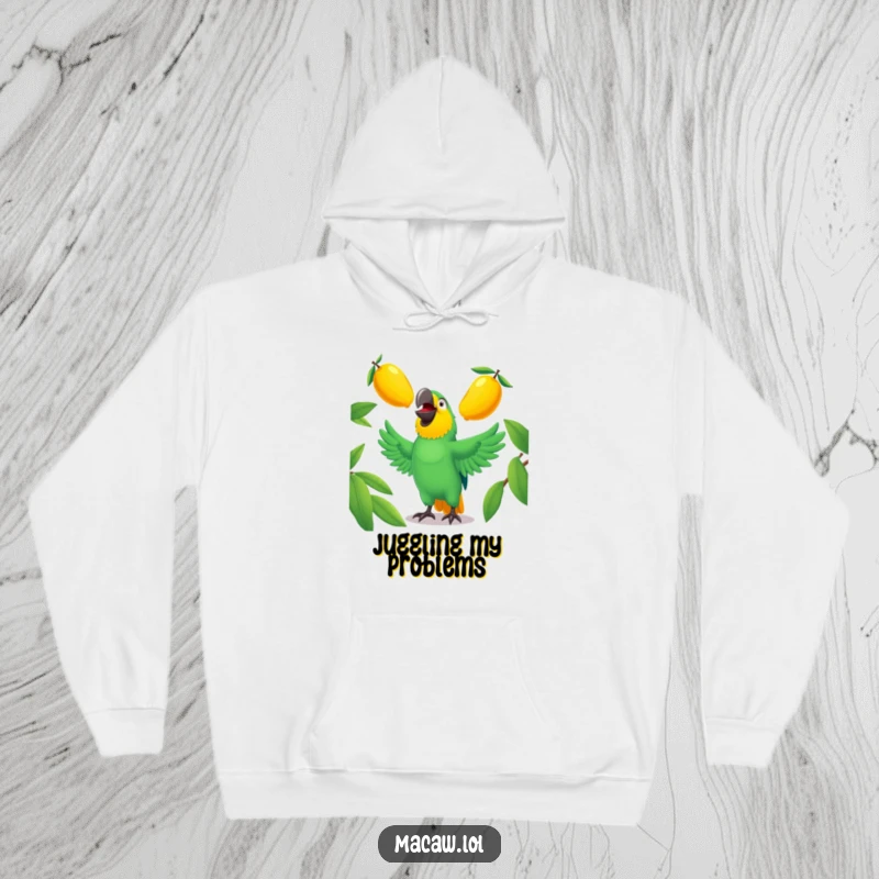 Funny macaw hoodie depicting a cheerful bird juggling shiny mangoes, offering warmth and humor.