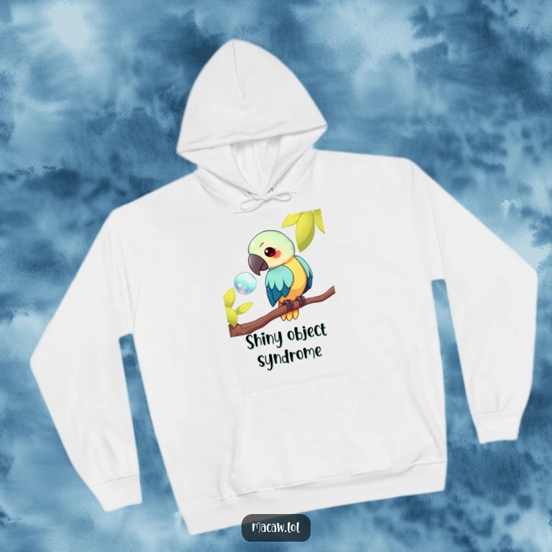 Funny kawaii macaw hoodie, featuring a bird on a branch curiously looking at a shiny object, offering cozy humor and fascination, a wonderful funny gift.