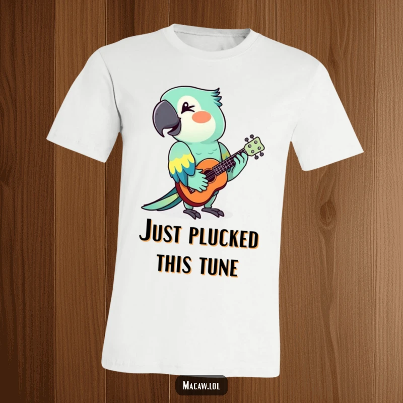 Funny macaw musician wearing sunglasses playing a ukulele with a wink, printed on a comfortable t-shirt.